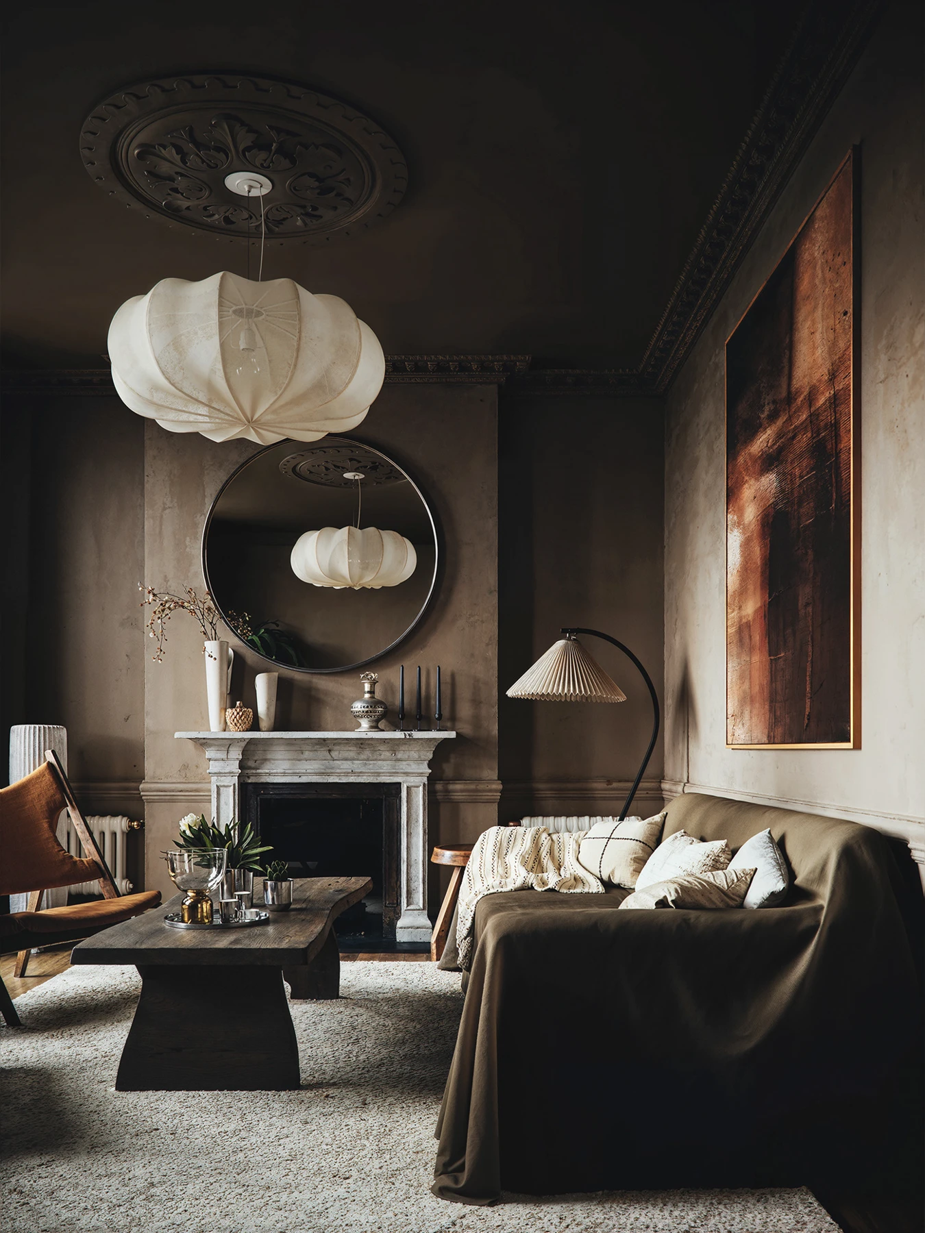 Interior with soft side lighting, dark furniture and warm tones
